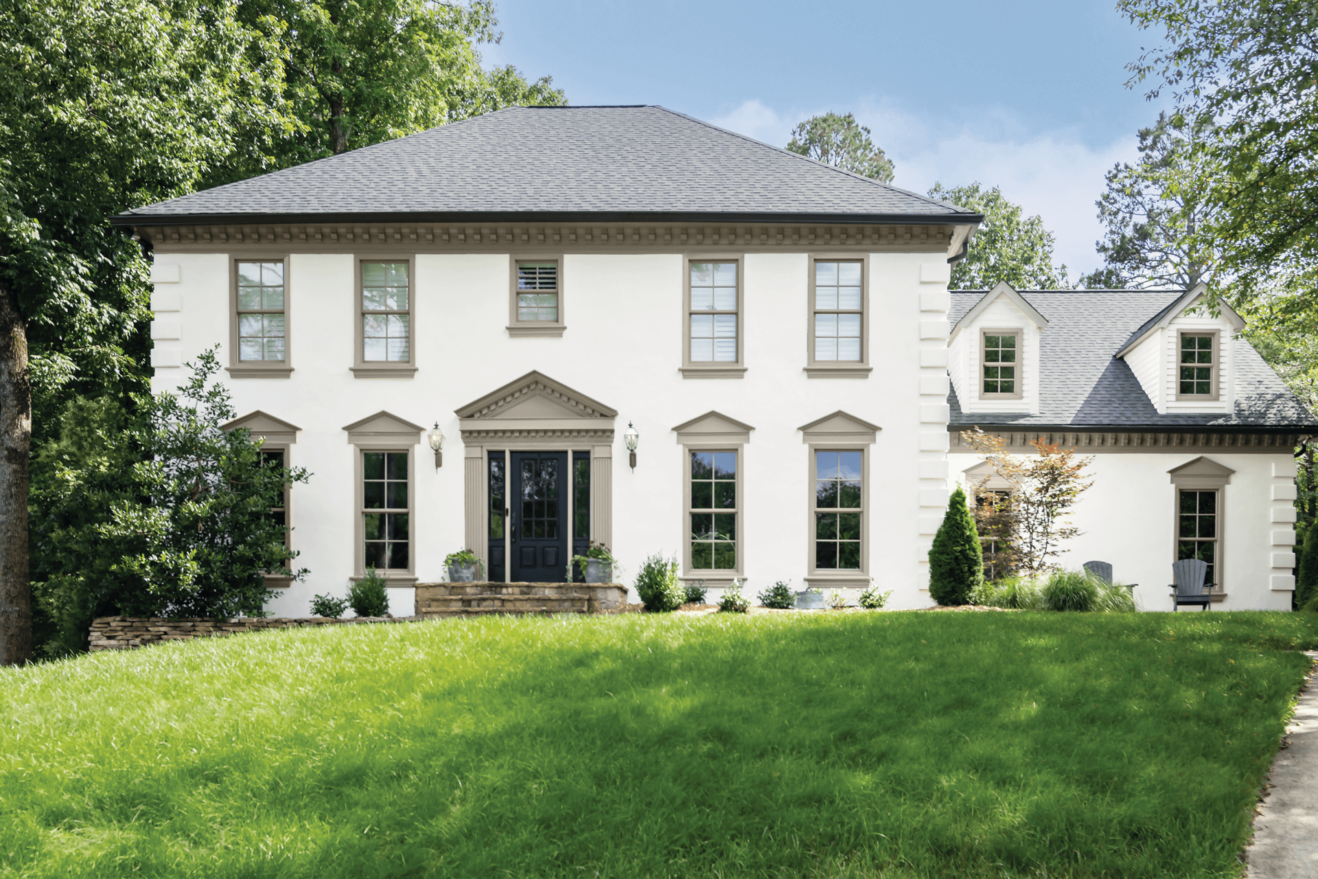 The exterior of a colonial home with Infinity from Marvin double hung windows.