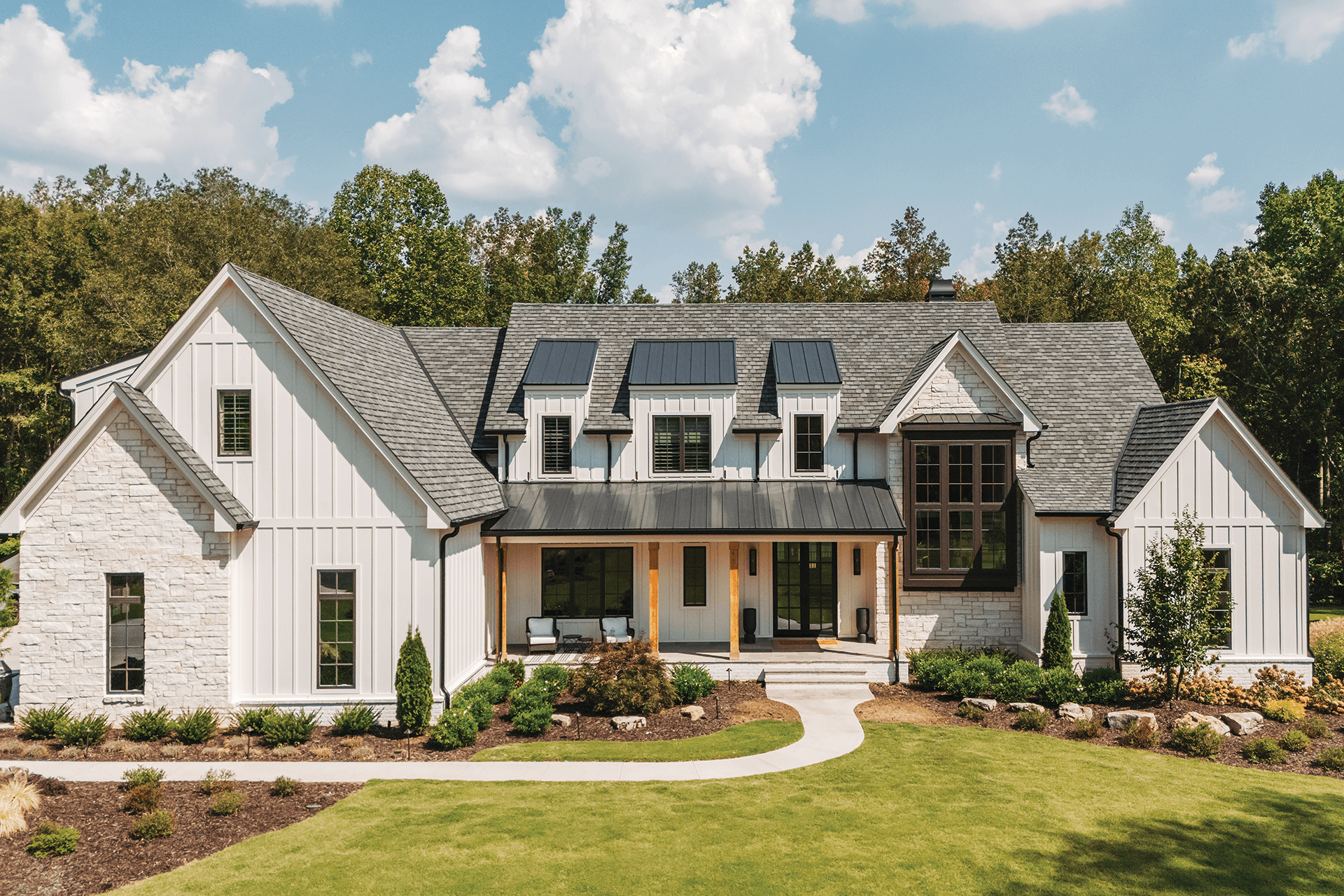 exterior shot of modern white farmhouse with infinity from marvin windows