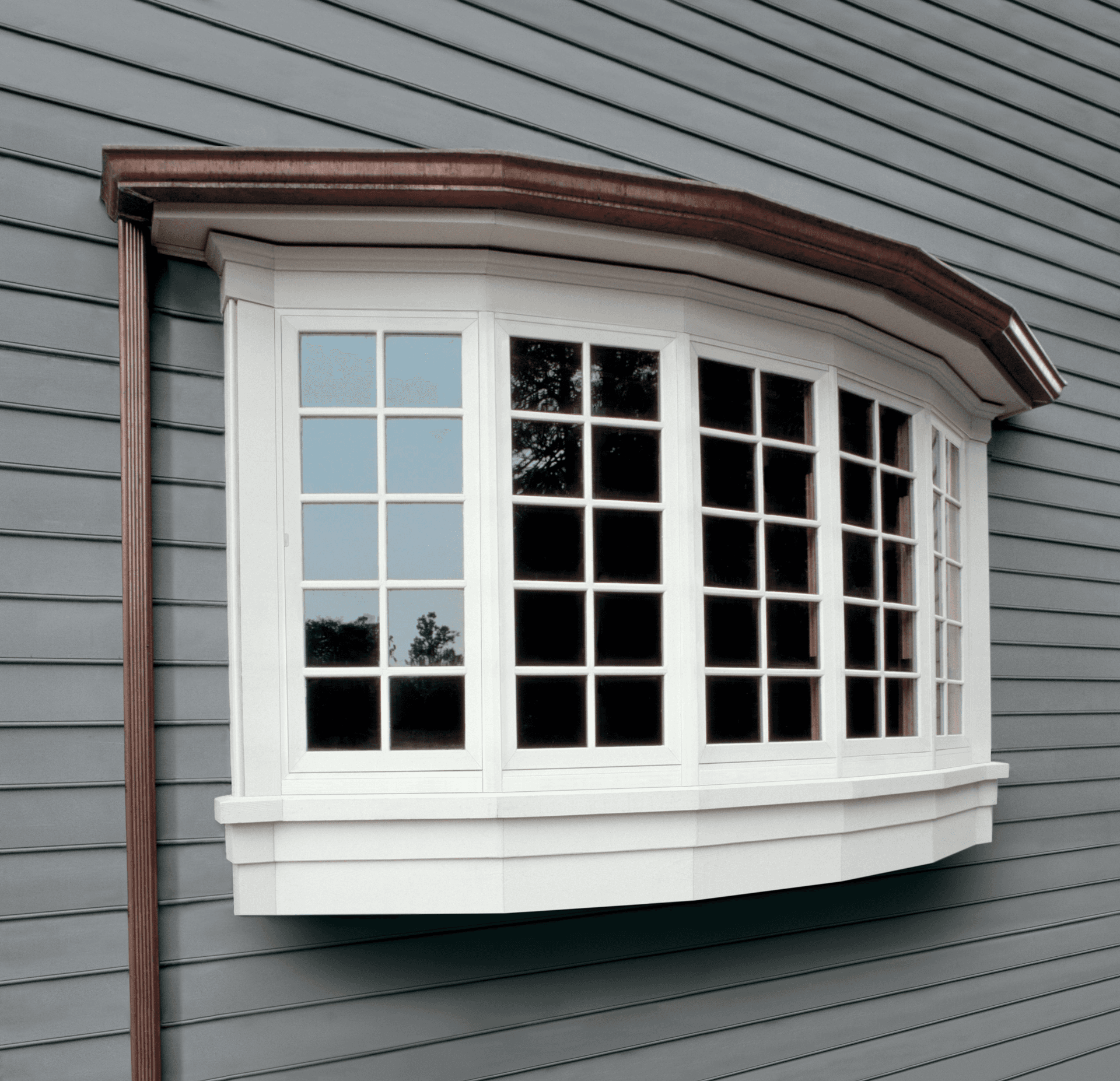 The exterior view of a white bow window.